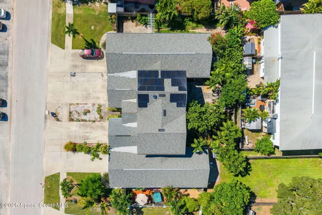 an aerial view of a house with yard swimming pool and outdoor seating