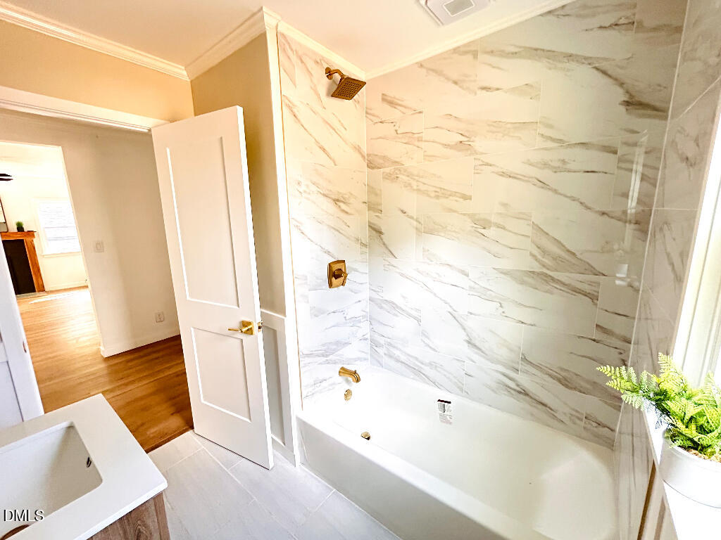 1606 James Street Durham, NC 27707 - Photo 19 of 24 a bathroom with a bathtub and a shower