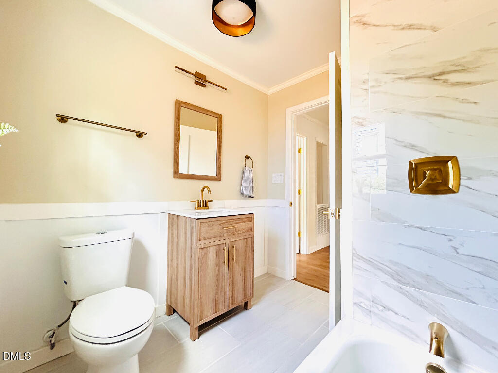 1606 James Street Durham, NC 27707 - Photo 20 of 24 a bathroom with a granite countertop toilet sink and mirror