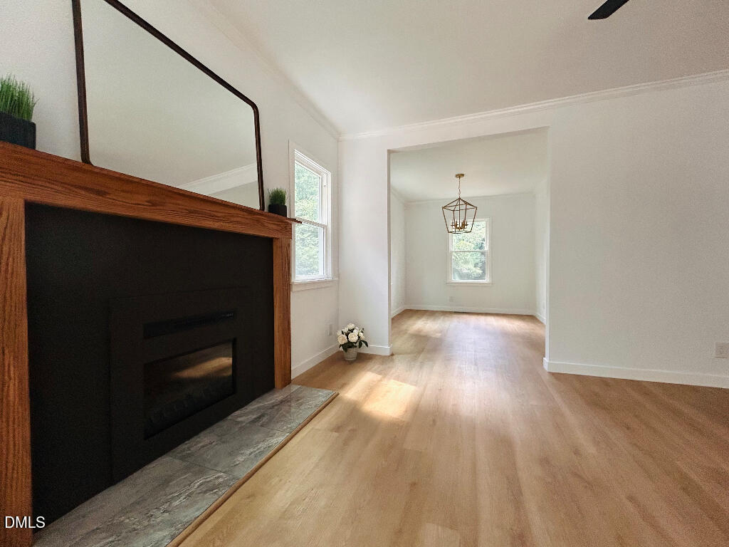 1606 James Street Durham, NC 27707 - Photo 6 of 24 a view of an empty room with wooden floor and a fireplace