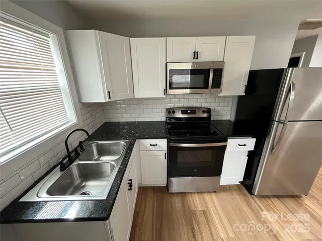 a kitchen with a refrigerator sink and microwave