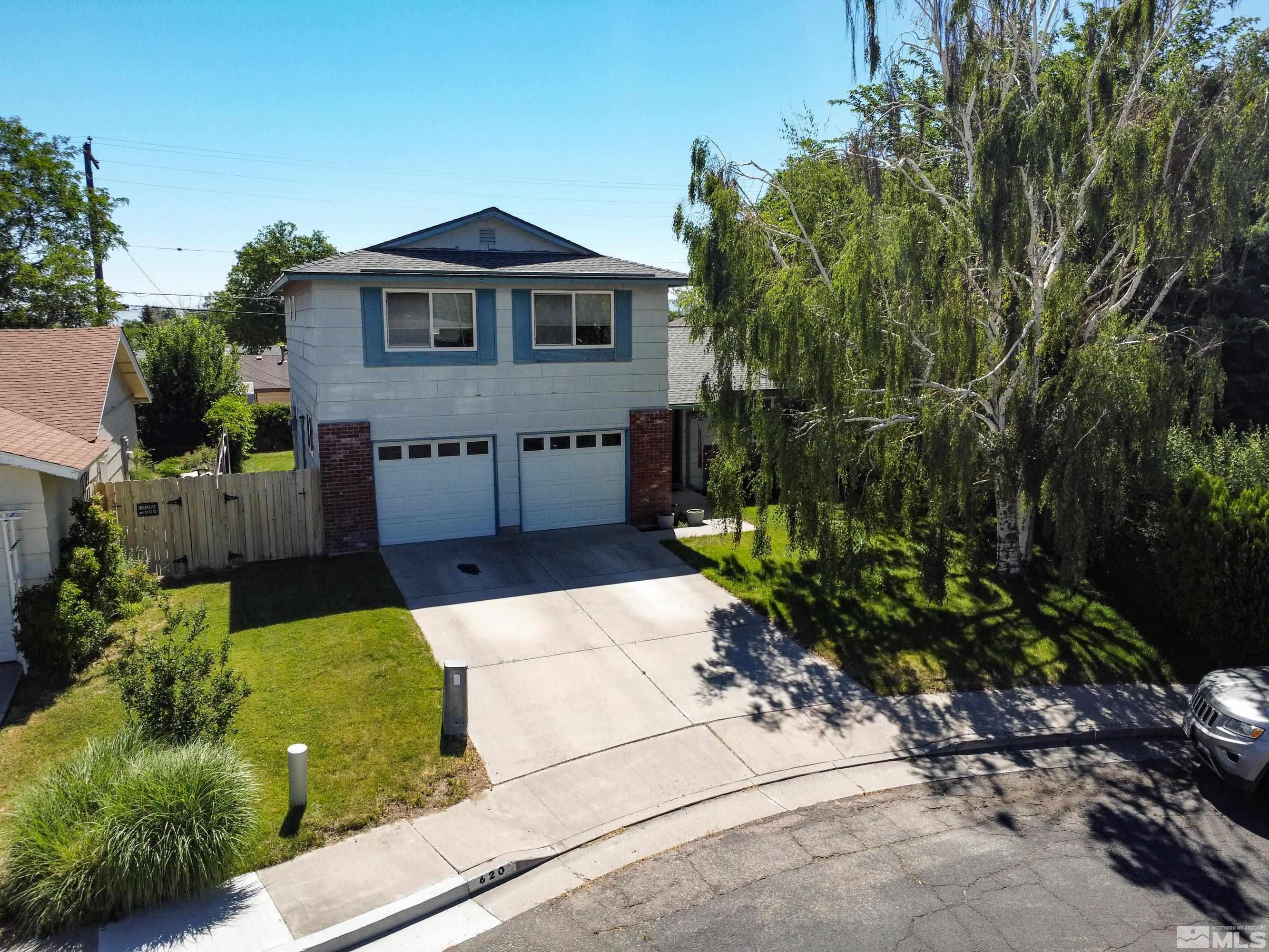 620 Nancy Circle Reno, NV 89503 - Photo 1 of 36 a front view of a house with a garden