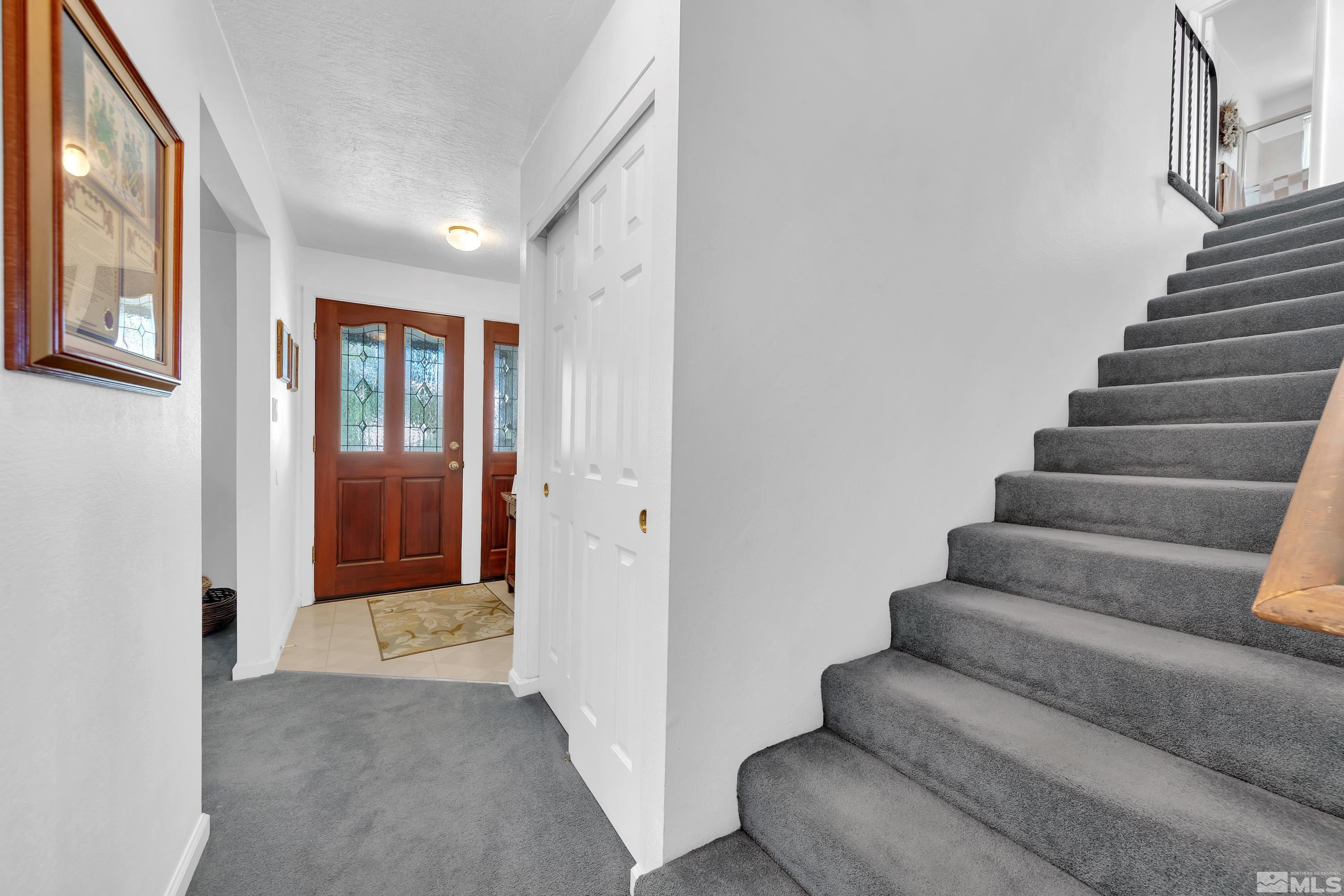620 Nancy Circle Reno, NV 89503 - Photo 11 of 36 a view of staircase with lots of frames on wall