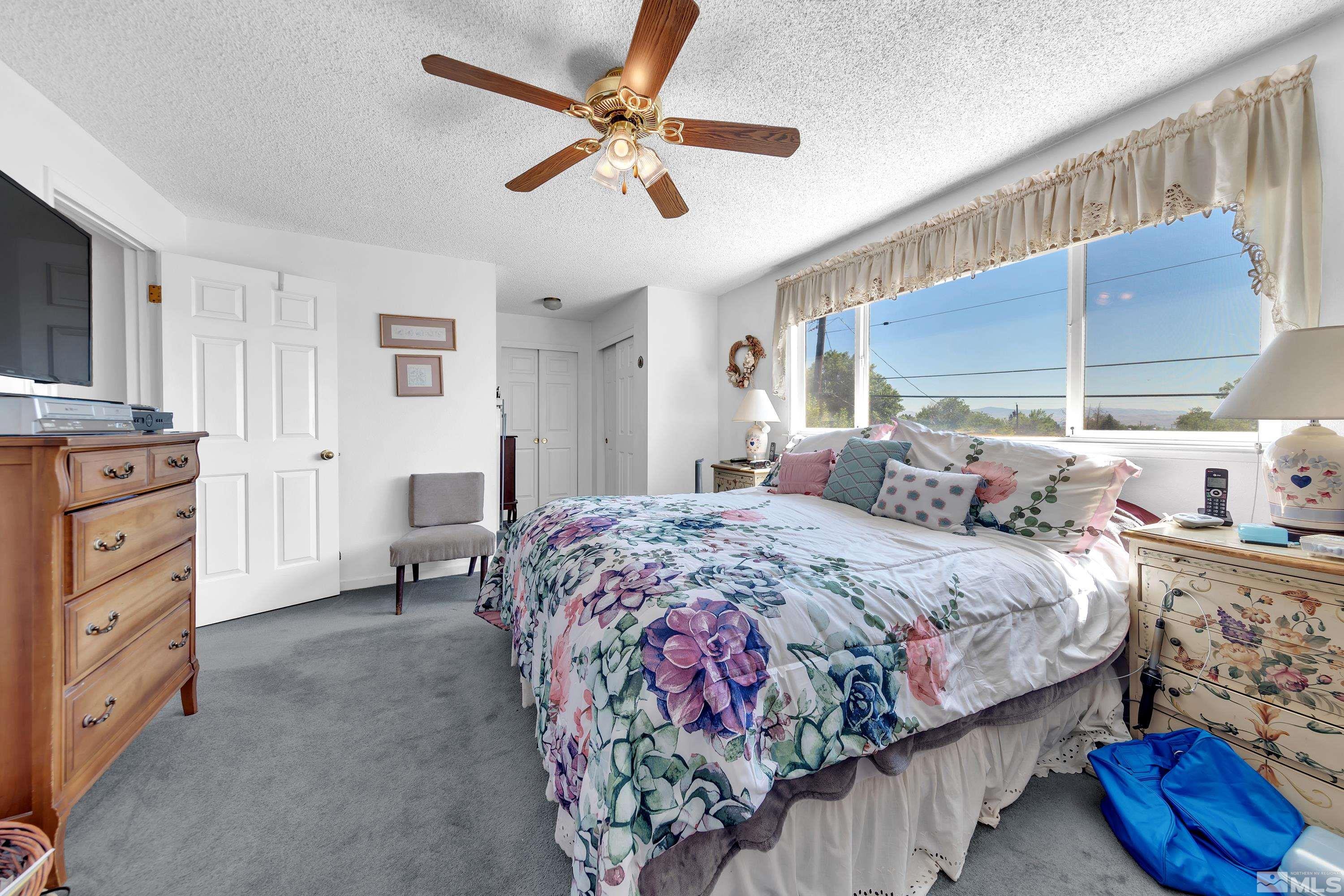 620 Nancy Circle Reno, NV 89503 - Photo 16 of 36 a bedroom with a bed and a chandelier