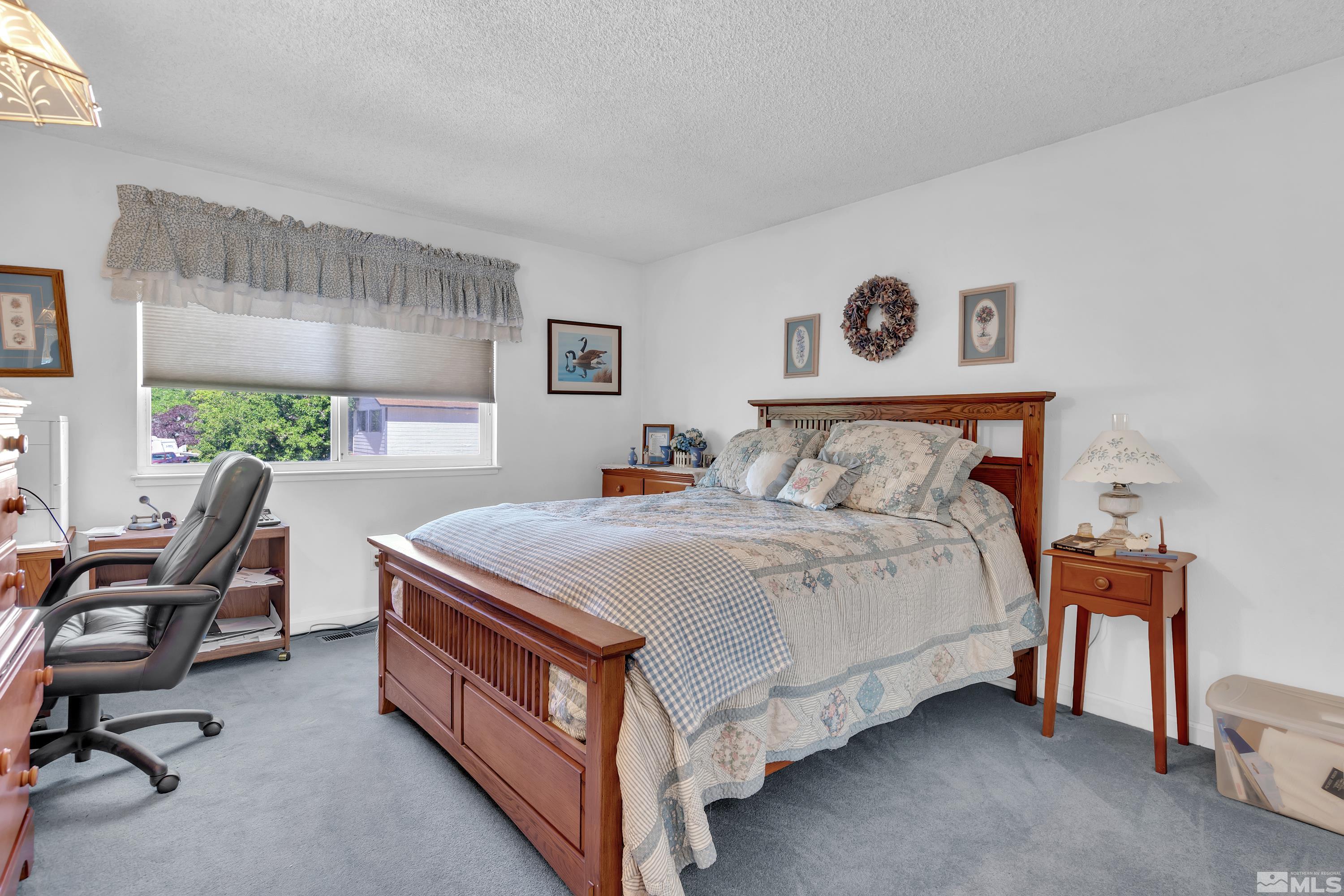 620 Nancy Circle Reno, NV 89503 - Photo 20 of 36 a bedroom with a bed a desk and chair