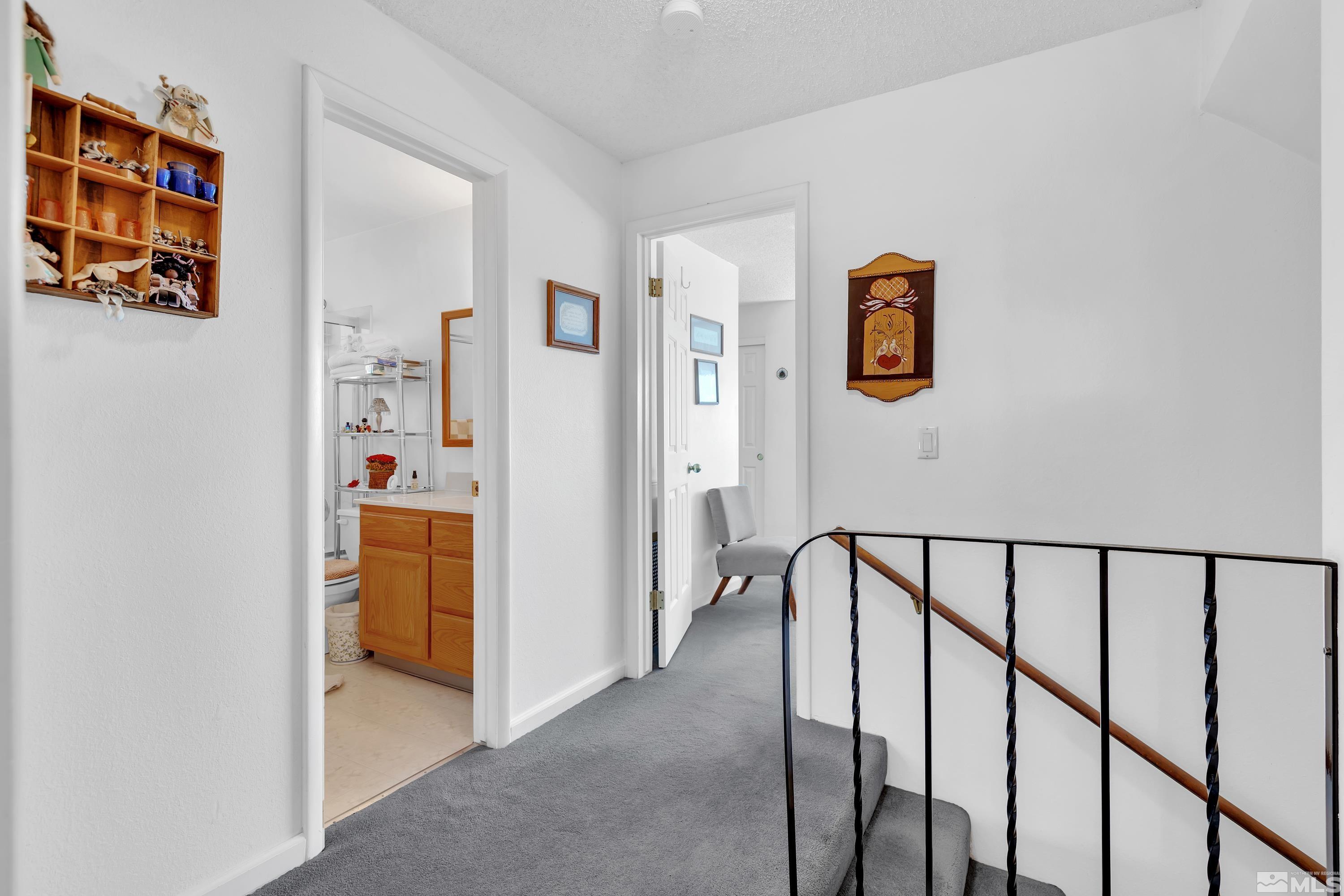 620 Nancy Circle Reno, NV 89503 - Photo 24 of 36 a view of a hallway with paintings on the wall