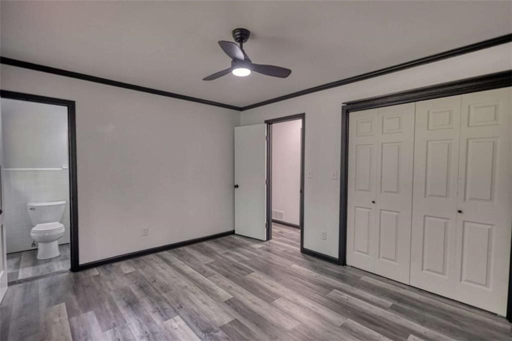 555 Joy Street Jackson, GA 30233 - Photo 42 of 56 a view of a livingroom with a hardwood floor and a ceiling fan