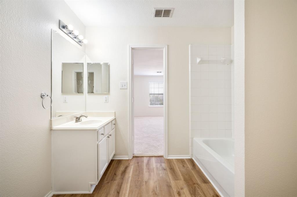 1626 White Oak Road Anna, TX 75409 - Photo 24 of 30 a bathroom with a sink a mirror and a shower