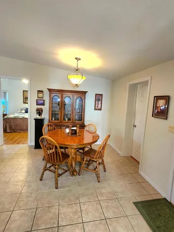 a kitchen with stainless steel appliances a refrigerator a sink a stove and white cabinets