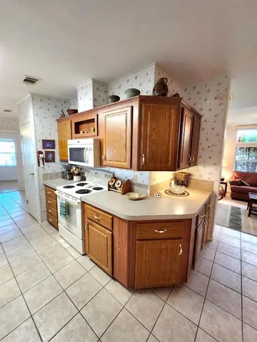 a kitchen with a sink cabinets and window