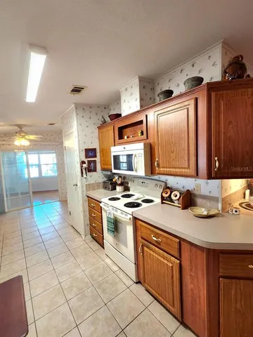 a kitchen with stainless steel appliances a stove a sink and a refrigerator