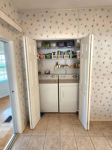 a bedroom with a bed a mirror and lamp