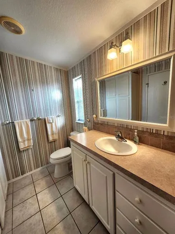 a bedroom with a bed and chandelier