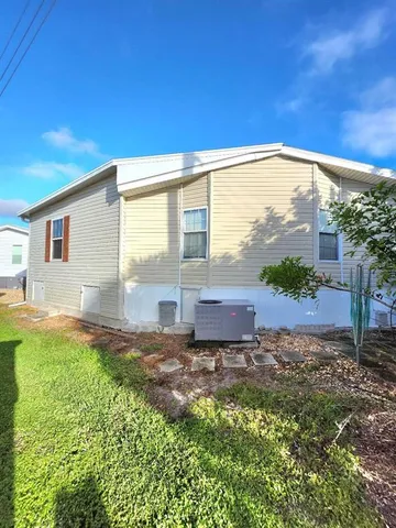 a living room with furniture a floor to ceiling window and a flat screen tv