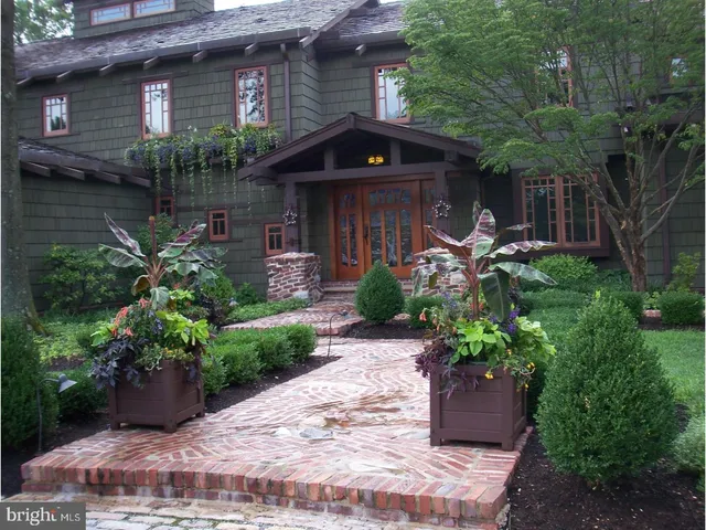 a dining room with furniture and a potted plant