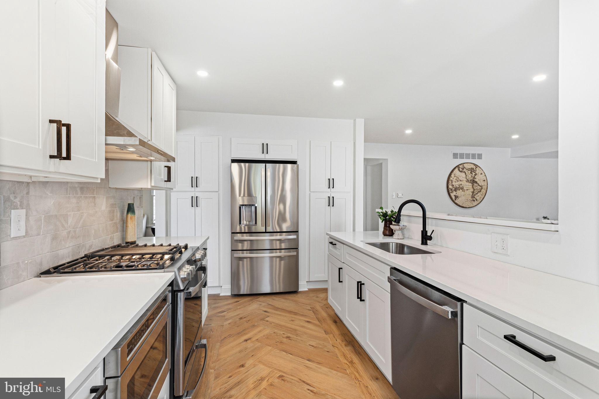 15162 Wayside Road Philadelphia, PA 19116 - Photo 11 of 34 a kitchen with stainless steel appliances granite countertop a sink stove and refrigerator