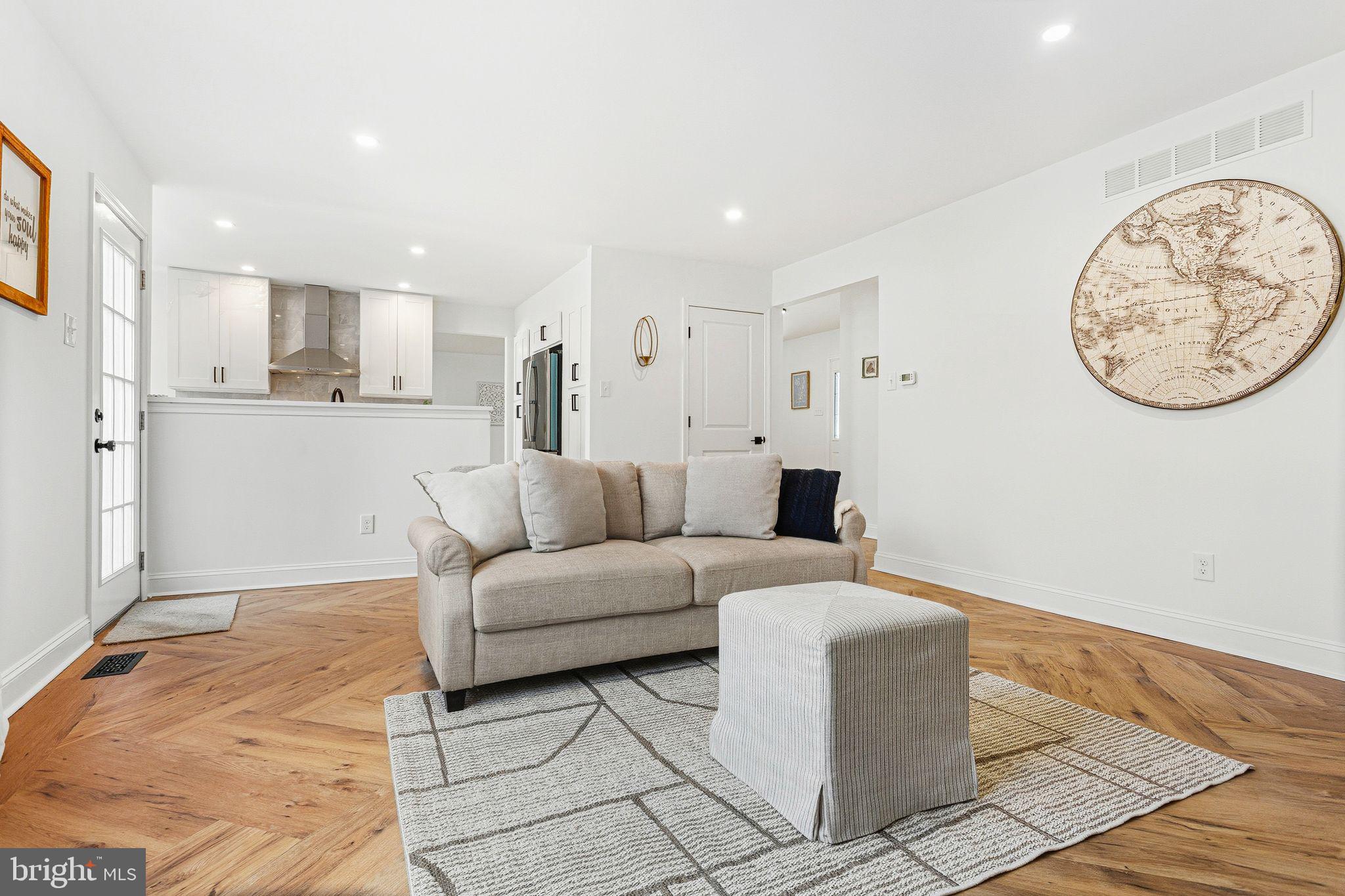 15162 Wayside Road Philadelphia, PA 19116 - Photo 15 of 34 a living room with furniture a wall clock and a window