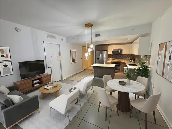 a kitchen with granite countertop a stove a sink and a refrigerator