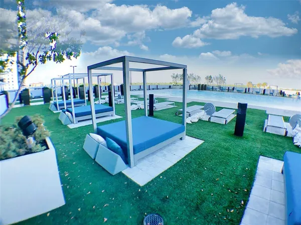 a view of a deck with couches with wooden floor & fence