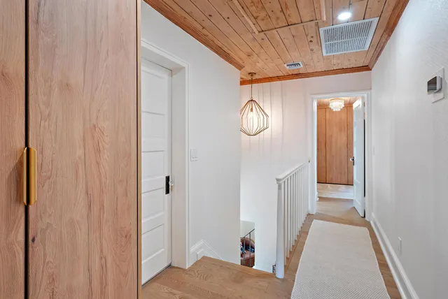 a bed sitting in a spacious bedroom next to a window