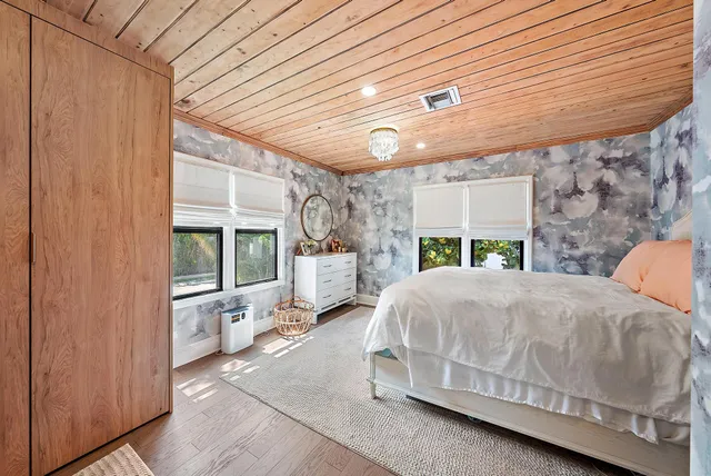 a spacious bedroom with a bed and a shower