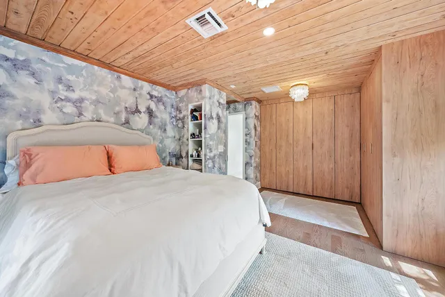 a bathroom with a granite countertop sink a mirror and a bathtub