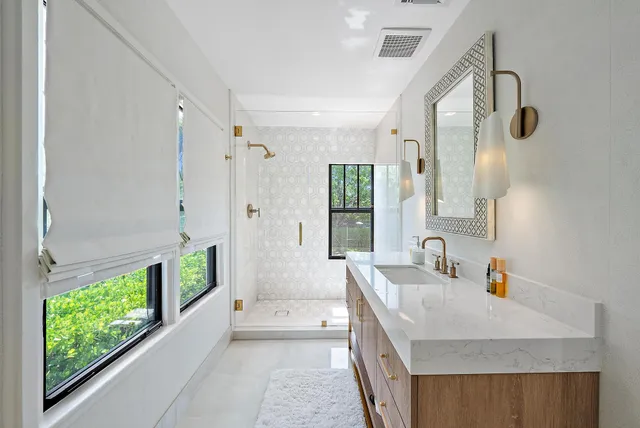 a bedroom with a bed a dresser and painting on the wall