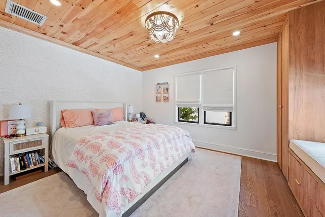 a bathroom with a sink a mirror and painting on the wall