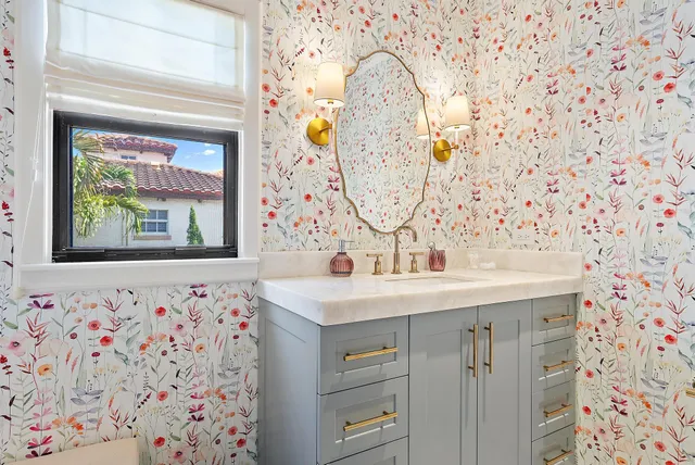 a bathroom with a sink mirror and toilet