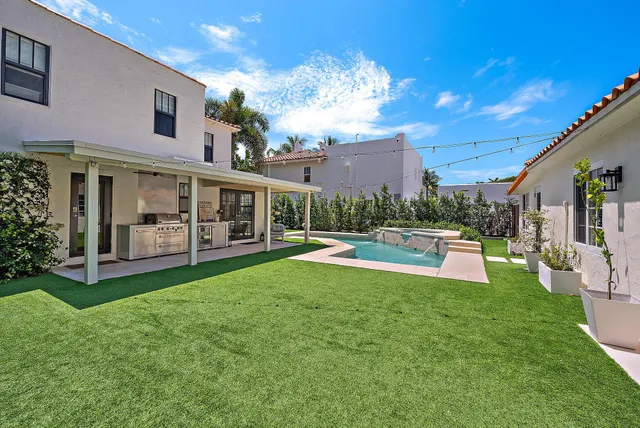 a view of a house with backyard sitting area and garden