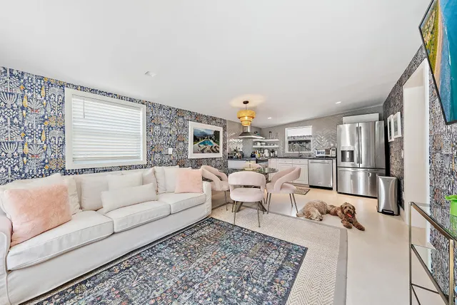 a kitchen with granite countertop stainless steel appliances white cabinets and a sink