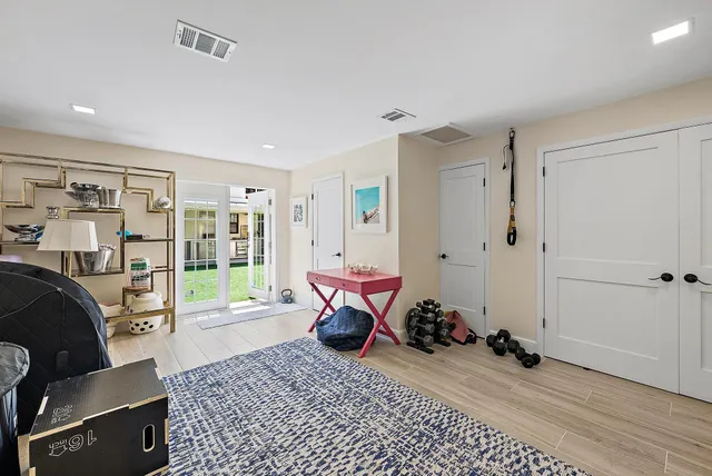 a bedroom with furniture and a wooden floor