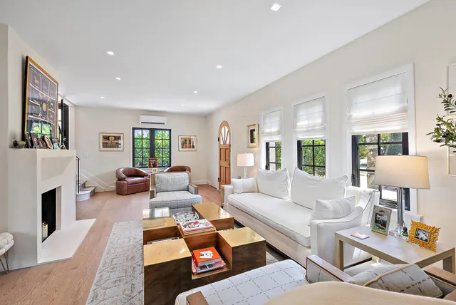 a living room with furniture fireplace and a window