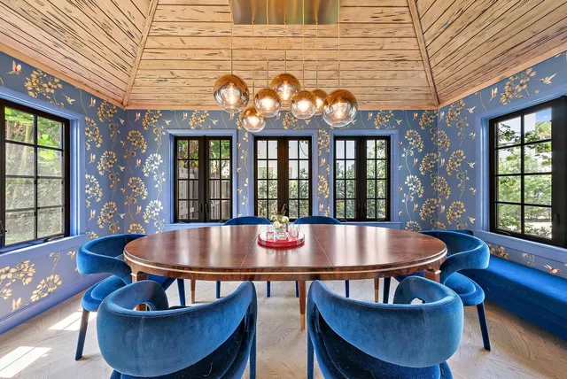 a dining room with furniture wooden floor and a chandelier