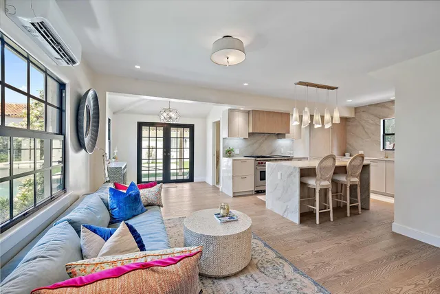 a living room with furniture and kitchen view