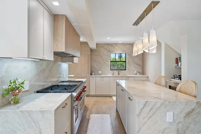 a kitchen with a sink stove and cabinets
