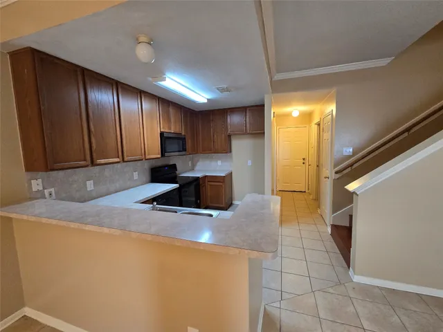a kitchen with stainless steel appliances granite countertop a sink a stove and a refrigerator