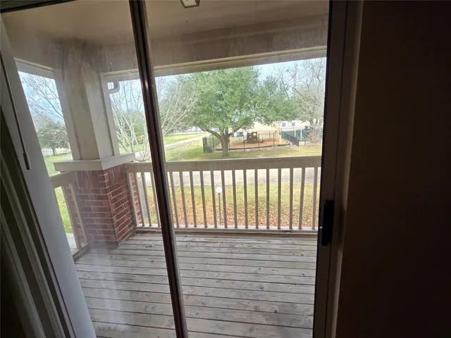 a view of balcony with wooden floor