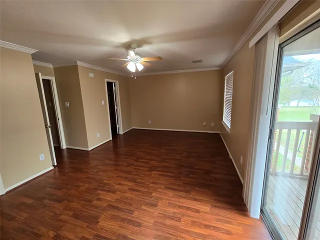 a view of a room with wooden floor and cabinet