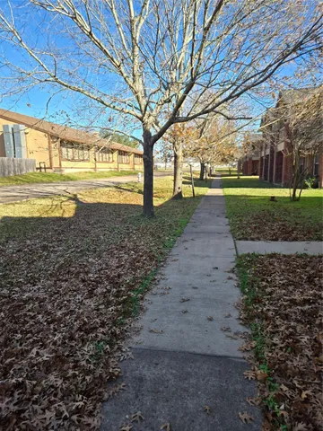 a view of yard with tree in the background