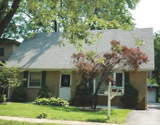 14327 Ridgeway Avenue Midlothian, IL 60445 - Photo 1 of 1 front view of a house with a yard and an trees