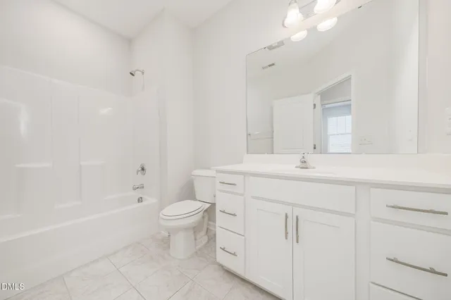 a bathroom with a toilet sink and a bathtub