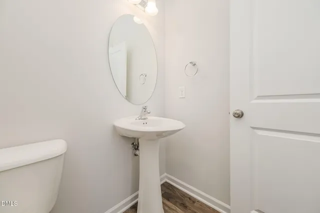 a bathroom with a sink toilet and a mirror