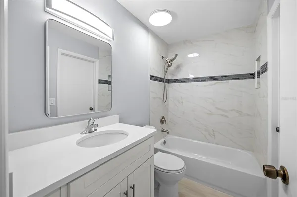 a bathroom with a sink toilet tub and shower