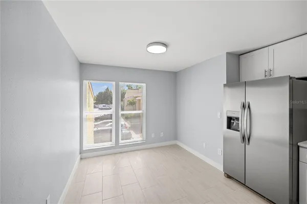 a view of a kitchen with a refrigerator cabinets and a window