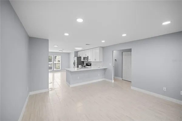 a view of a kitchen with a sink and cabinets
