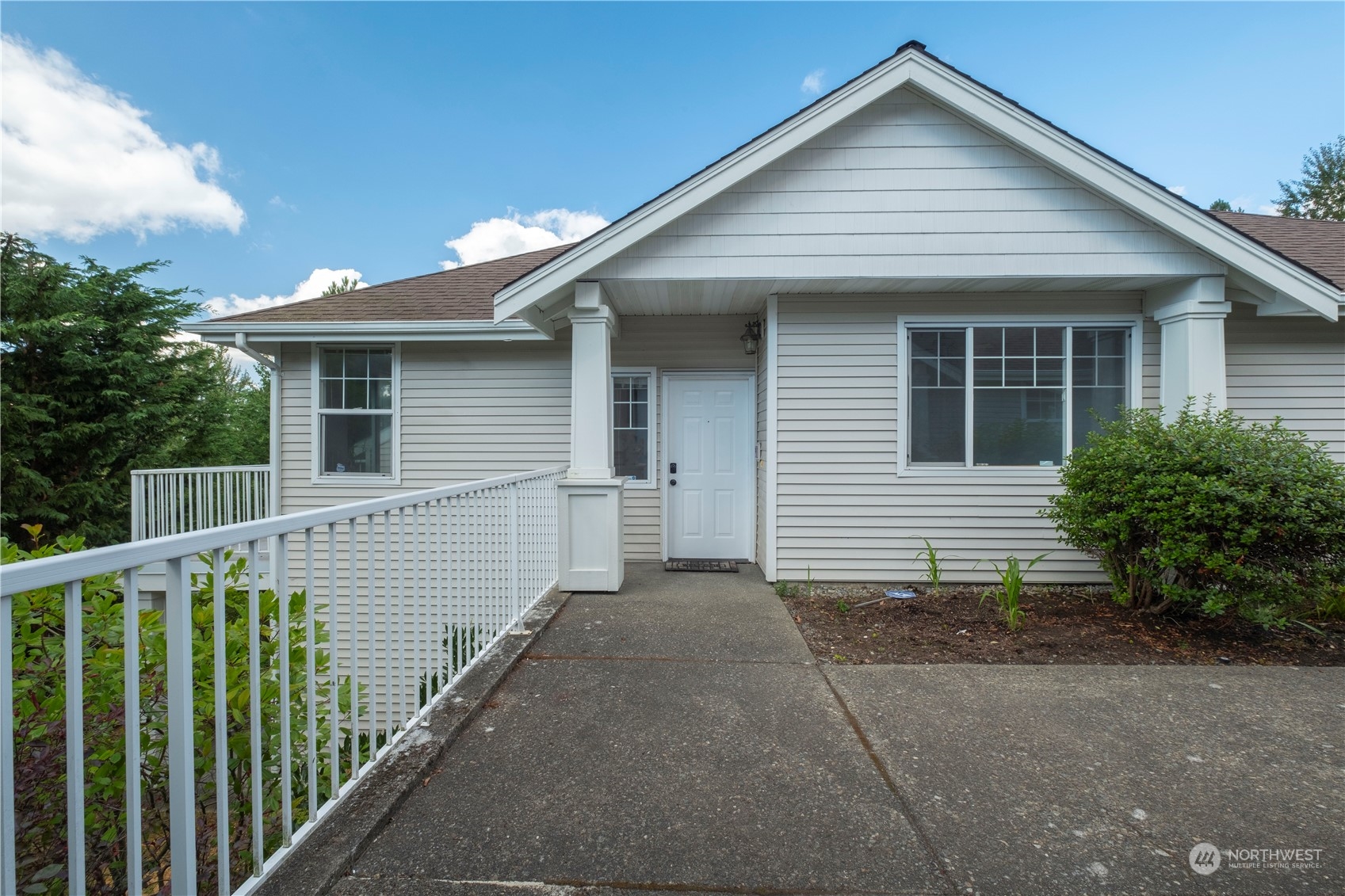 2300 Benson Road South, Unit H1 Renton, WA 98055 - Photo 1 of 27 a front view of house with yard and trees in the background