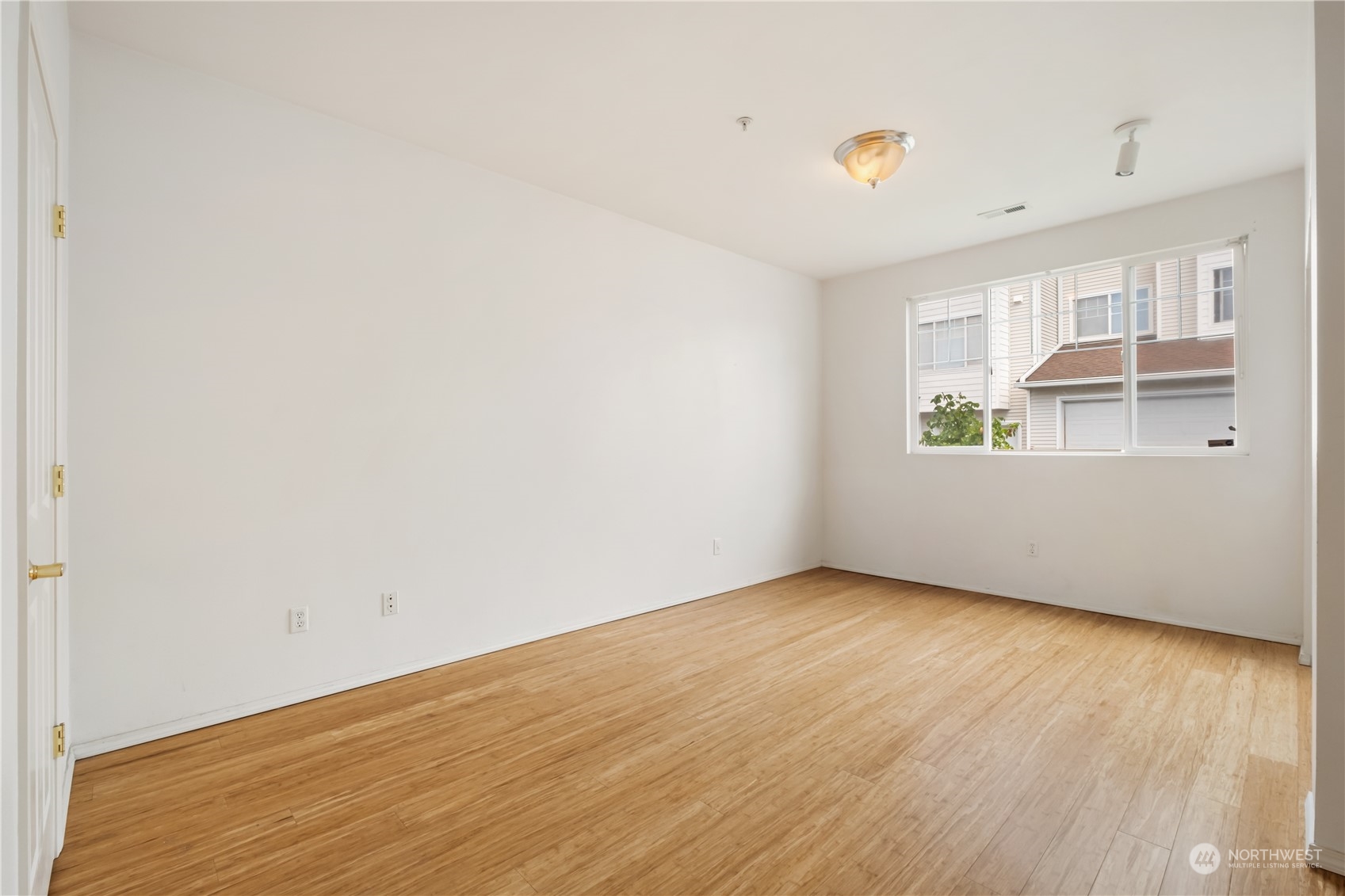 2300 Benson Road South, Unit H1 Renton, WA 98055 - Photo 13 of 27 an empty room with wooden floor and windows
