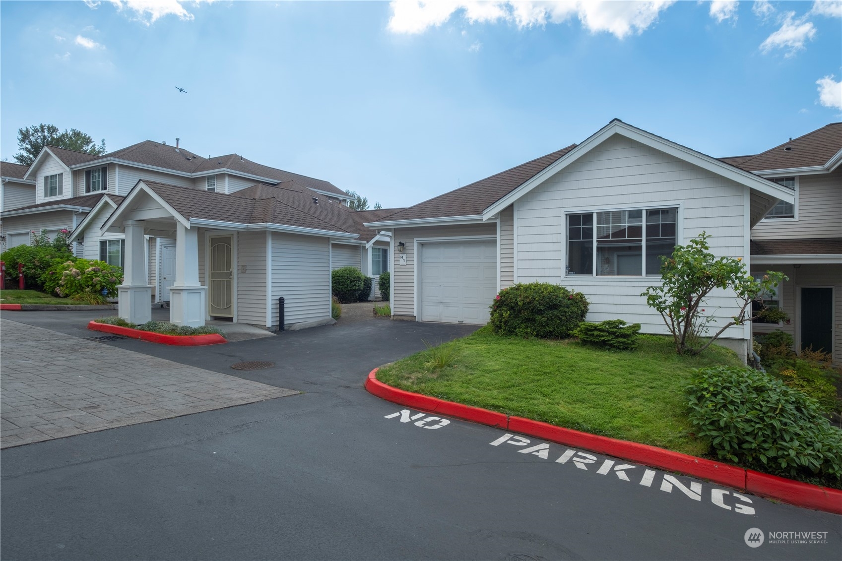 2300 Benson Road South, Unit H1 Renton, WA 98055 - Photo 2 of 27 a front view of a house with a yard and garage