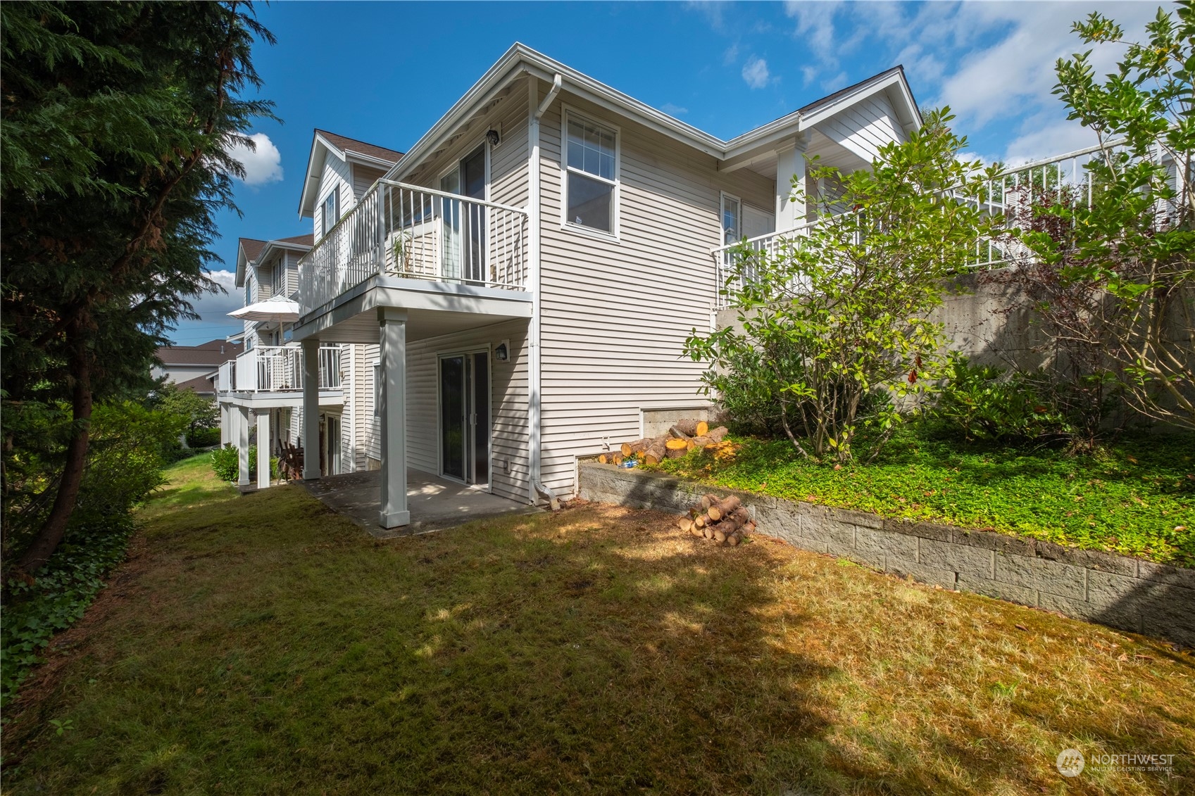 2300 Benson Road South, Unit H1 Renton, WA 98055 - Photo 23 of 27 a front view of a house with a garden and yard